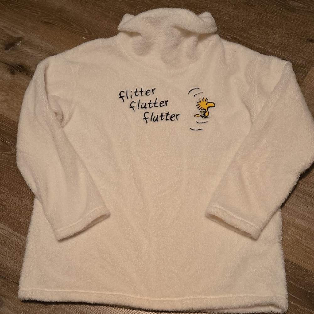 Cozy Cream Turtleneck Sweater with Embroidered 'Flutter' Accent